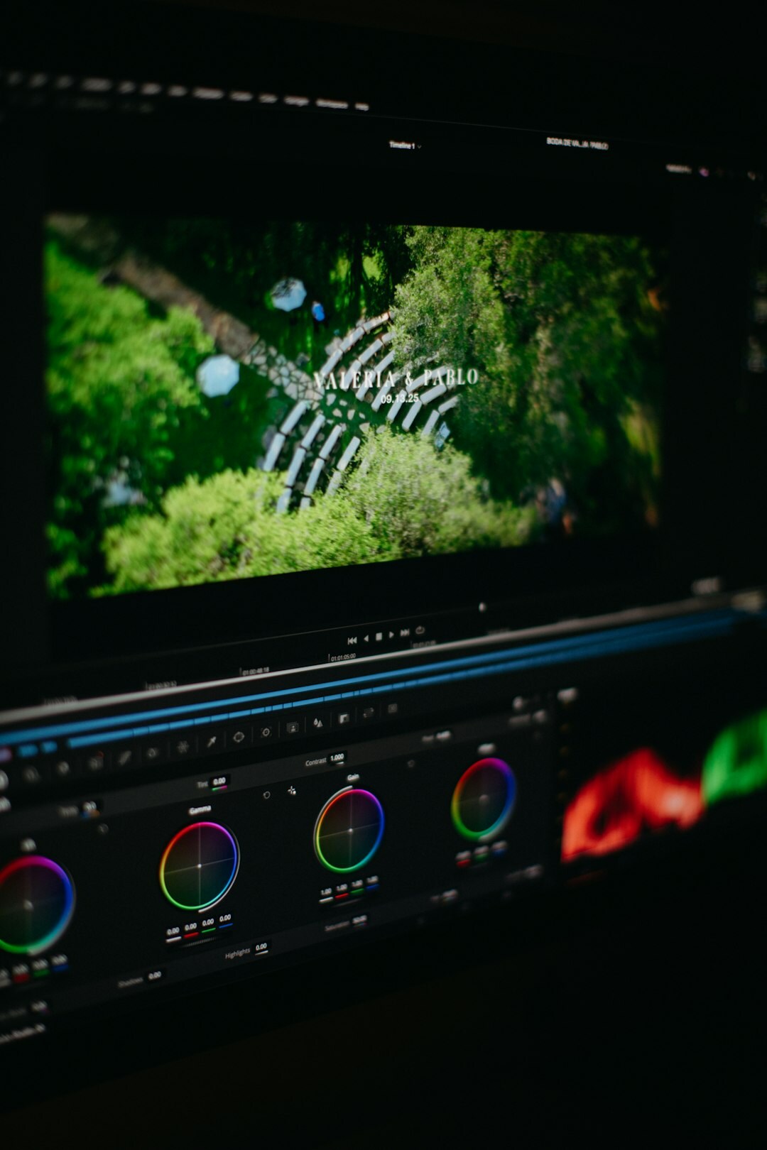 Video editor working at a post-production editing suite with color grading monitors