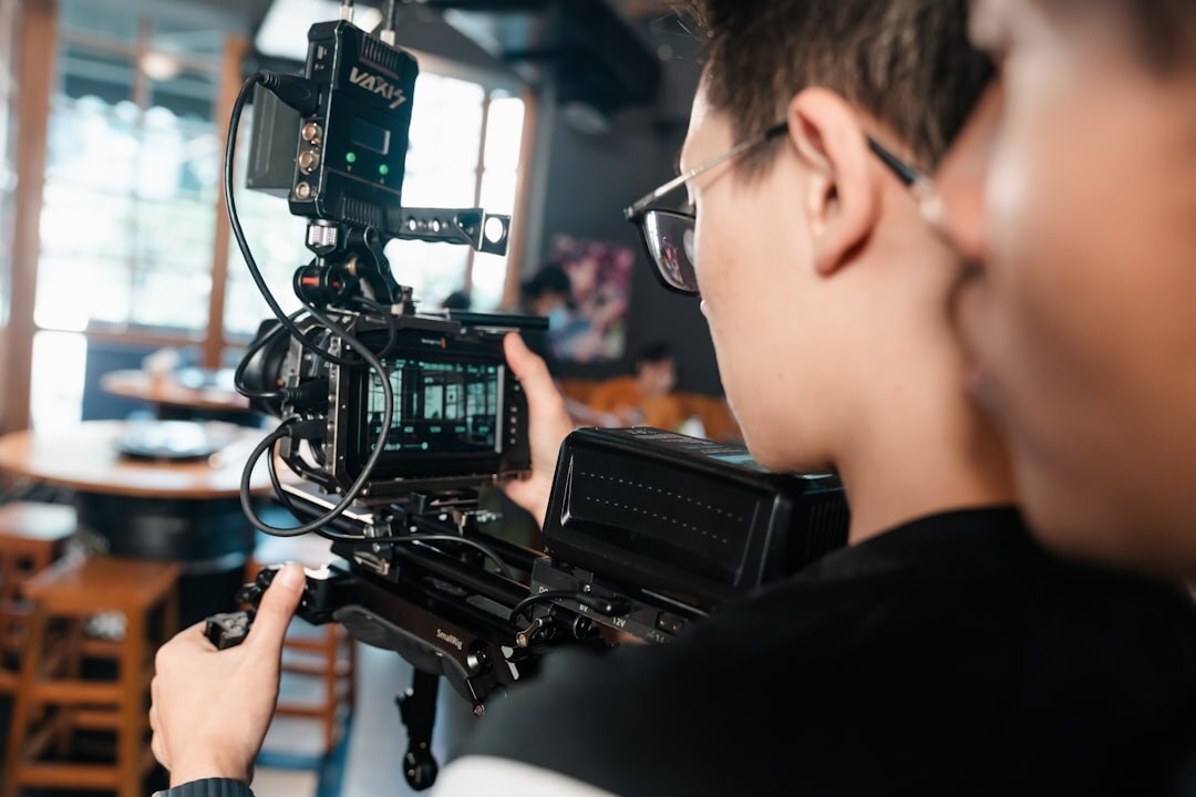 Professional camera operator filming with a broadcast camera on a shoulder rig